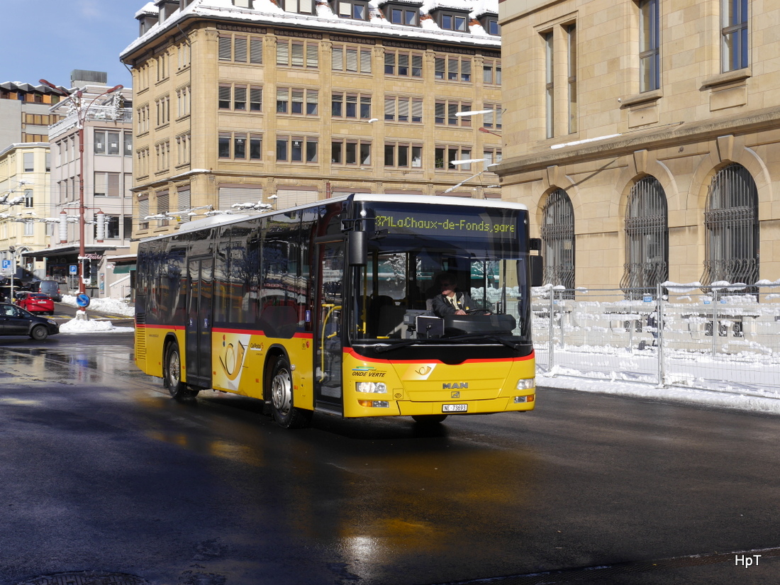 Postauto - MAN Lion`s City  NE 73693 unterwegs vor dem Bahnhof in La Chaux de Fonds am 18.01.2015
