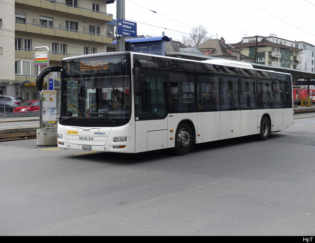 Postauto / Ortsbus Brig/Glis - MAN Lion`s City  VS  449116 vor dem SBB Bhf. Brig am 26.02.2023