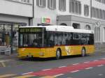 Postauto Postauto - MAN  SG 284108 bei den Bushaltestellen vor dem Bahnhof in Herisau am 16.01.2010