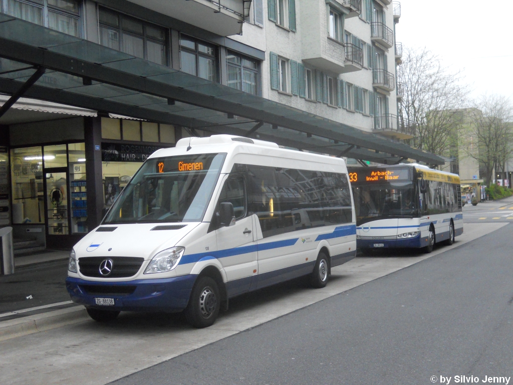 ZVB Nr. 138 (Mercedes Sprinter) und Nr. 136 (Solaris Alpino 8.6) am 1.5.2010 in Zug, Bahnhofplatz. Eigentlich wrde ja der Solaris im Hintergrund auf der Linie 12 fahren. Doch aufgrund eines Ausfalls des Scanias auf dem 33er, war der Solaris dort eingeplant, und der Sprinter fuhr auf der Linie 12.