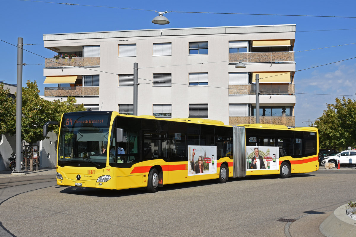 Mercedes Citaro 58, auf der Linie 64, verlässt die Haltestelle beim Bahnhof Dornach. Die Aufnahme stammt vom 18.09.2018.