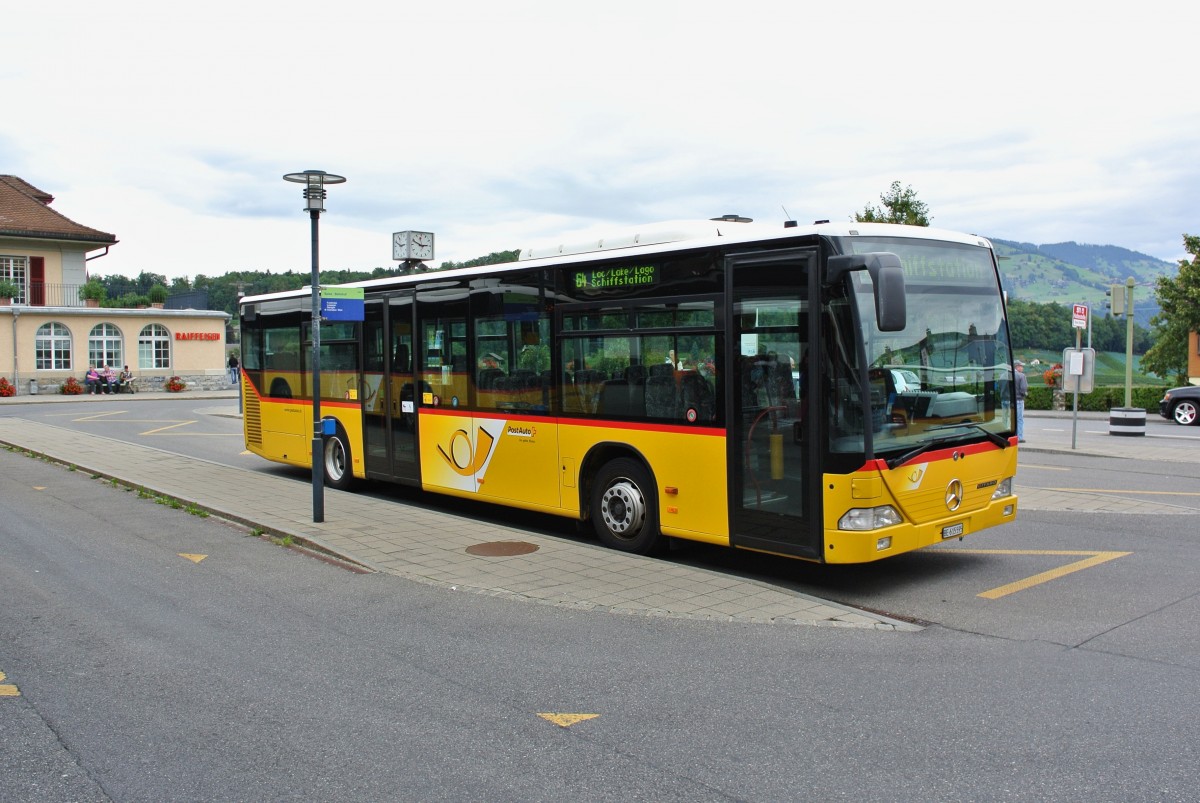 Postauto Citaro I auf der Linie 64 beim Bahnhof Spiez, 20.08.2014.