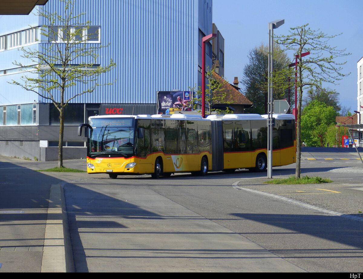 Postauto - Mercedes Citaro  BE  734634 bei der zufahrt zu den Haltestellen beim Bahnhof Zollikofen am 01.05.2022