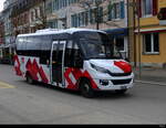 Postauto - Iveco  JU  35166 unterwegs in Delemont am 08.04.2023
