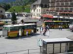 Hier ein NAW BH 4(PostAuto, PU AVG) und ein MAN LN 363 von GrindelwaldBus am Bahnhof in Grindelwald (Aufgenommen am 23.05.2010)