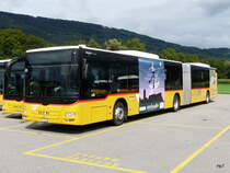 Postauto - MAN Lion`s City  JU 53406 abgestellt auf einem Parkplatz einer Garage etwas ausserhalb von Delemont am 08.09.2013