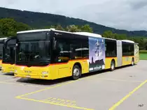 Postauto - MAN Lion`s City  JU 53406 abgestellt auf einem Parkplatz einer Garage etwas ausserhalb von Delemont am 08.09.2013
