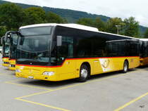 Postauto - Mercedes Citaro  JU 65081 abgestellt auf einem Parkplatz einer Garage etwas ausserhalb von Delemont am 08.09.2013