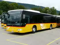 Postauto - Mercedes Citaro  JU 65081 abgestellt auf einem Parkplatz einer Garage etwas ausserhalb von Delemont am 08.09.2013