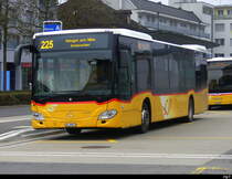 Postauto - Mercedes Citaro  ZH 90873 bei den Haltestellen vor dem Bahnhof in Affoltern am Albis am 30.03.2025 