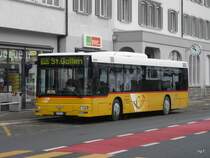 Postauto - MAN  SG 284108 bei den Bushaltestellen vor dem Bahnhof in Herisau am 16.01.2010